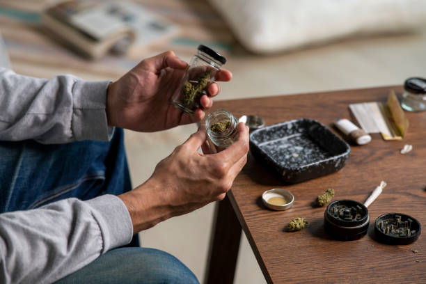 istock Young Asian man preparing marijuana at home. 1469968353