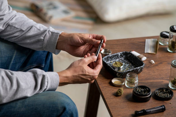 istock Young Asian man preparing a marijuana vaporizer at home. 1469968358