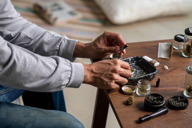 istock Young Asian man preparing a marijuana vaporizer at home. 1469968359