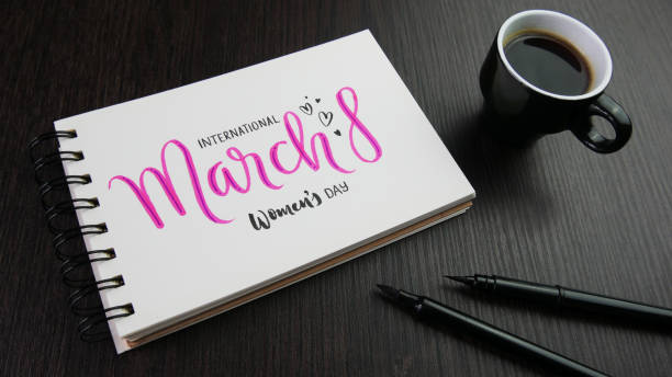 INTERNATIONAL WOMEN'S DAY - MARCH 8 pink and black lettering in notebook