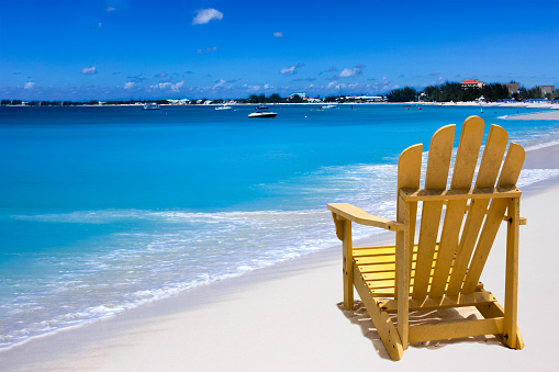 Yellow chair on a white sand Caribbean coast
