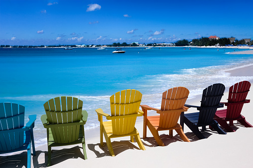 Colorful chairs on a white sand Caribbean coast