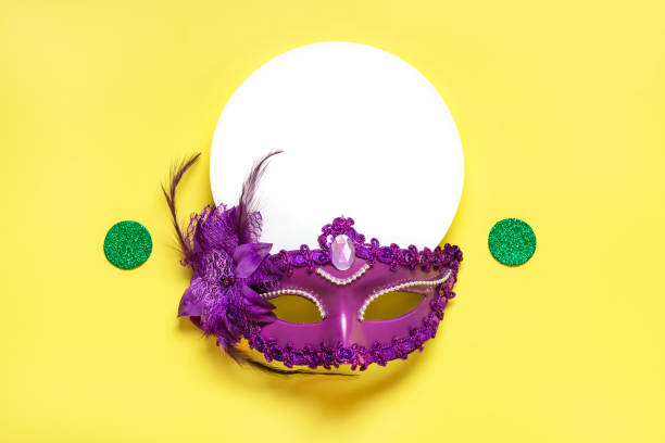 istock Mardi gras concept. Congratulation card with violet mask on yellow background Top view 2023 Mardi Gras Parade Schedule Mockup Copy space 1469970655