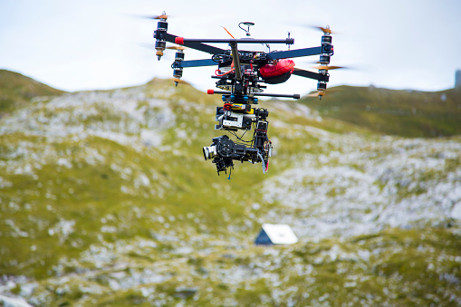 Drone filming the scene in mountains. Mountain hut in the background.