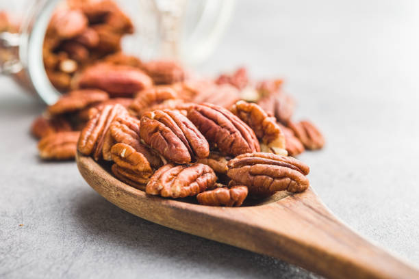 istock Peeled pecan nuts in wooden spoon. 1469972285