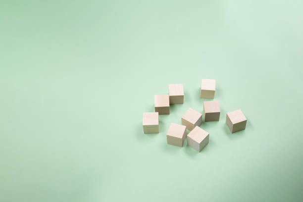 istock Wooden cubes randomly scattered on a green background. Copy space . 1469973680