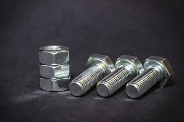 istock Metal bolts and nuts on black background are used in construction 1469973896