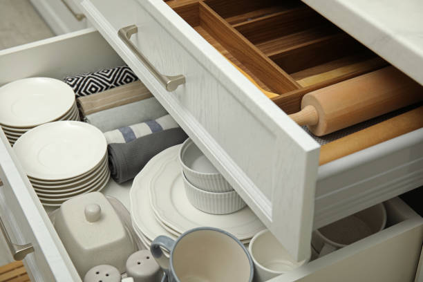 istock Open drawers of kitchen cabinet with different dishware, utensils and towels 1469974053