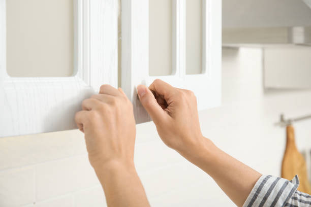 istock Woman opening cabinet doors at home, closeup 1469974450