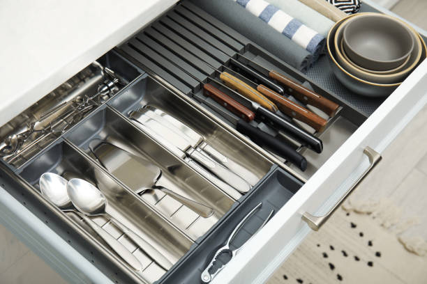 istock Open drawer of kitchen cabinet with different utensils, dishware and towels 1469974452