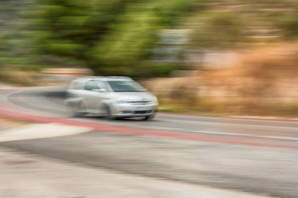 The car is driving at high speed on the autobahn. Motion blur. Copy-space.