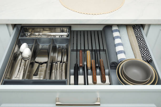 istock Open drawer of kitchen cabinet with different utensils, dishware and towels 1469975417