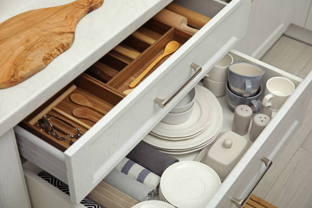 offene schubladen des küchenschranks mit verschiedenen geschirr, utensilien und handtüchern - schublade stock-fotos und bilder