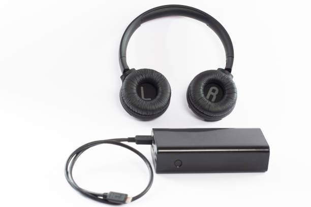 istock Wireless bluetooth headphones on a white background with a power bank. 1469977425