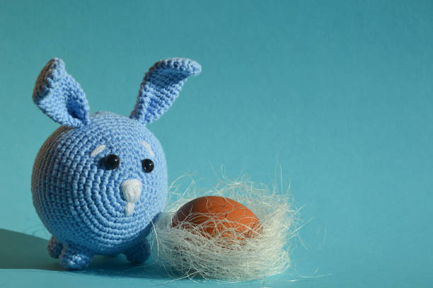 istock a blue toy rabbit and a chicken egg. background for Happy Easter decoration. spring holiday. 1469978178