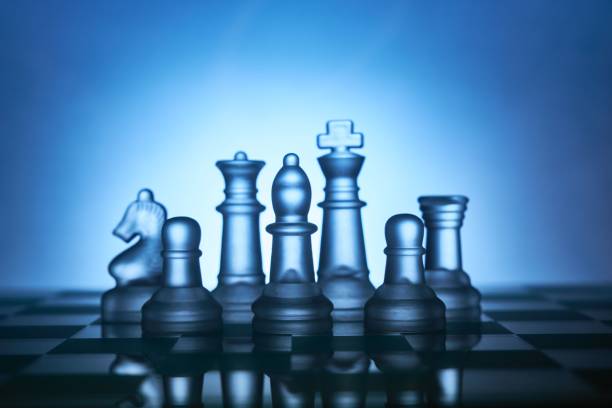 istock Transparent chess figures on a chess board in close-up. 1469978833