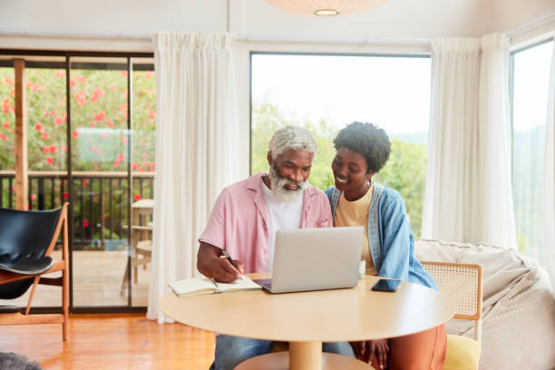 istock Smiling couple doing their home finances together on a laptop 1469979146