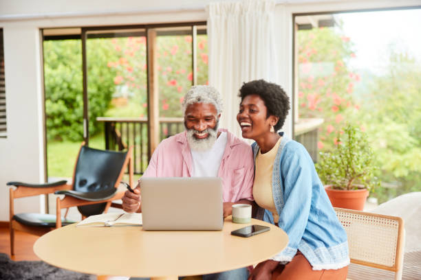 istock Laughing couple doing their finances on a laptop at home 1469979801