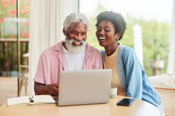 istock Couple laughing while doing their home finances together on a laptop 1469980094