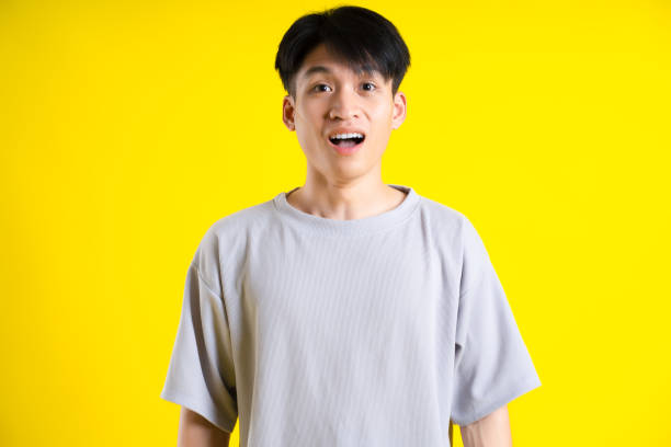 istock image of handsome young man posing on a yellow background 1469981028