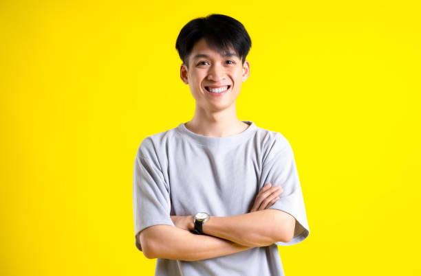 istock image of handsome young man posing on a yellow background 1469981029