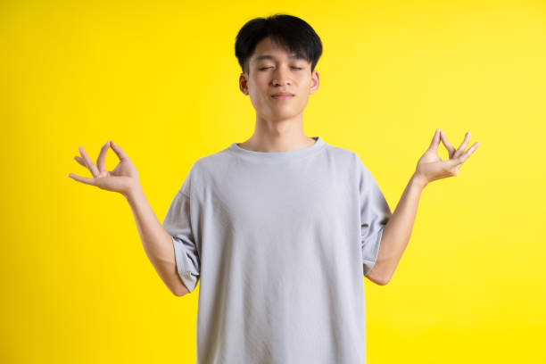 istock image of handsome young man posing on a yellow background 1469981621
