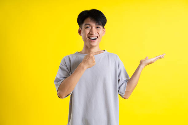 istock image of handsome young man posing on a yellow background 1469981624