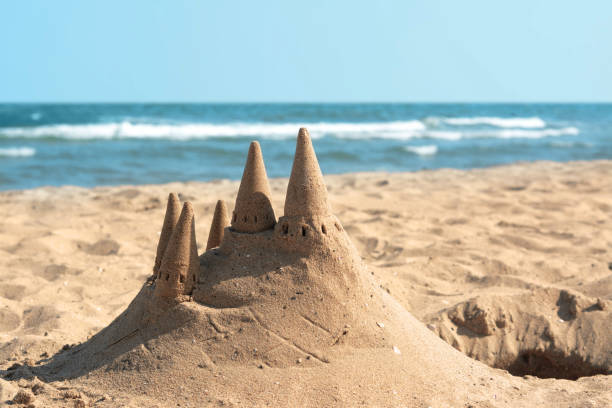 istock Beach with sand castle near sea on sunny day 1469981962