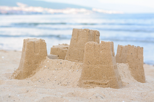 Beautiful sand castle on beach near sea