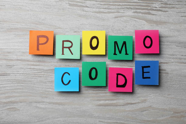istock Words Promo Code made of colorful paper notes with letters on wooden table, flat lay 1469982342