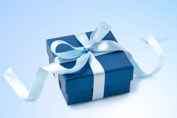istock Gift box with ribbon bow on light blue background 1469982864
