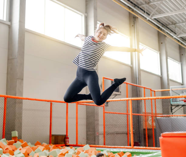 istock Pretty girl in trampoline park having fun 1469983920