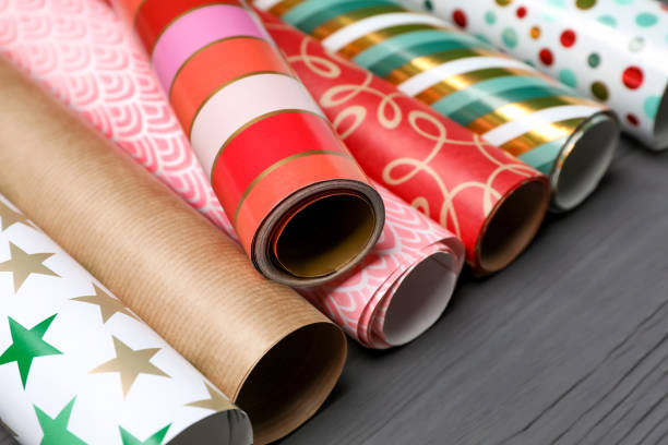 istock Different colorful wrapping paper rolls on grey wooden table, closeup 1469984218
