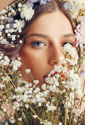 Woman, beauty and flower portrait for natural skincare, cosmetics makeup and floral head crown. Spring flowers, organic body care and skin wellness with facial headshor or dermatology glow in studio