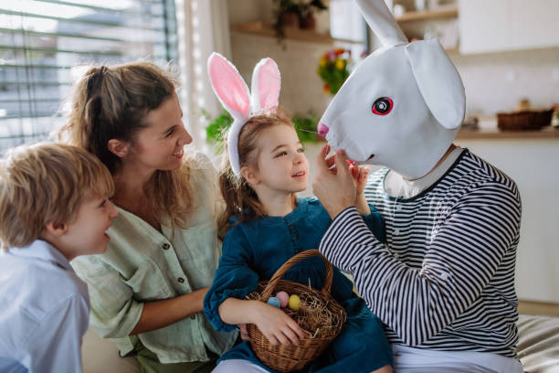 istock Little children having fun with her mother and Easter rabbit, celebrating Easter. 1469986448