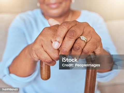 istock Life insurance, hope and hands of old woman with walking stick for a disability or balance in a nursing home. Zoom and elderly person with funeral cover, marriage ring and gratitude in retirement 1469986465