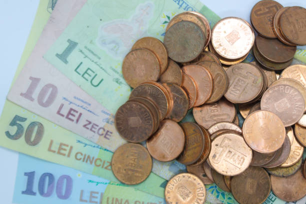 istock Closeup of 5 bani coins on Romanian Leu RON currency notes 1469987512