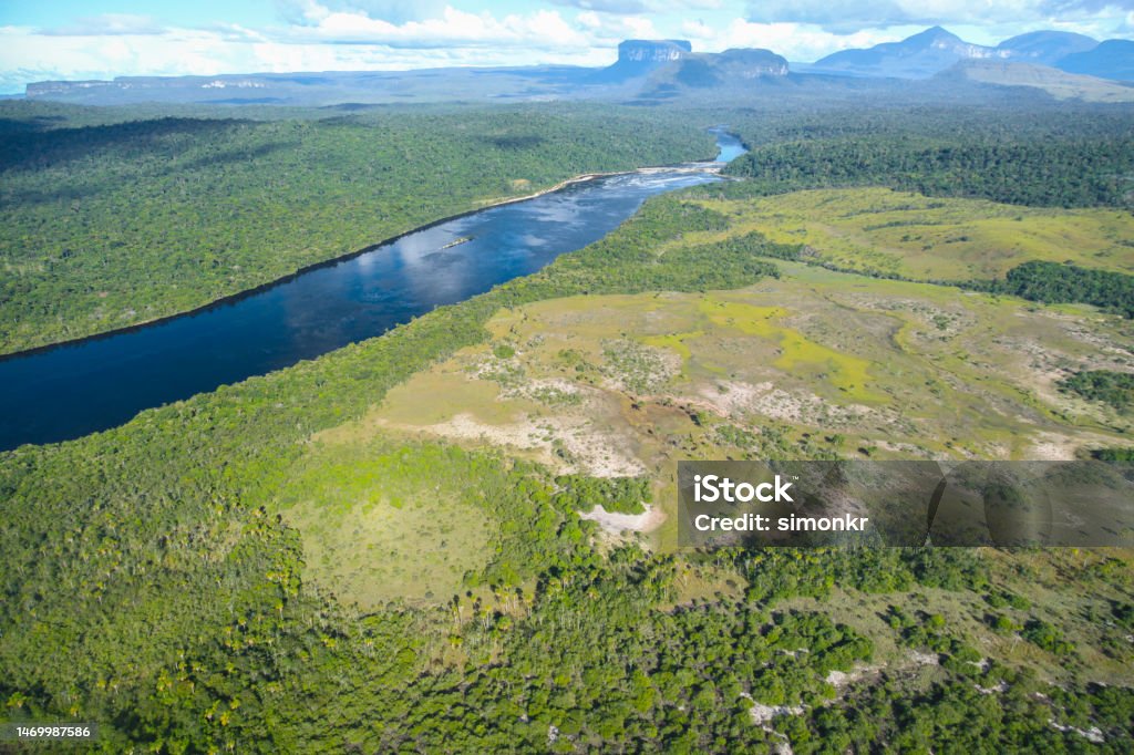 Amazon rainforest and Rio Churun River Aerial view of Rio Churun River flowing amidst Amazon rainforest at Canaima National Park, Bolivar State, Venezuela. Aerial View Stock Photo