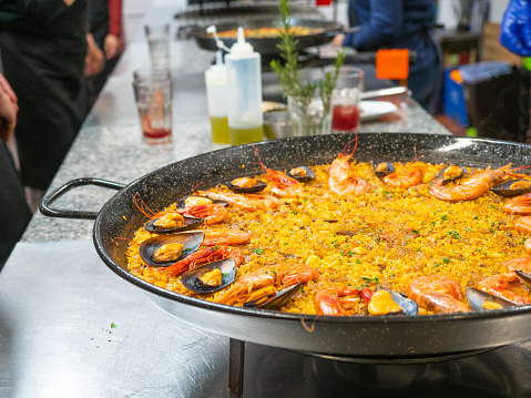 great seafood paella pan with rice, mussels and prawns in cooking class. Traditional Spanish cuisine regional, Valencia.