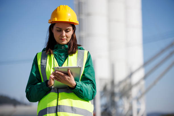 istock Portrait of female engineer with hardhat using digital tablet while working on her work site 1469988013