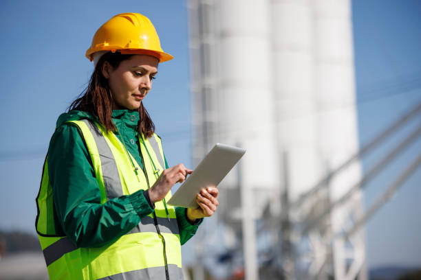 istock Portrait of female engineer with hardhat using digital tablet while working on her work site 1469988057