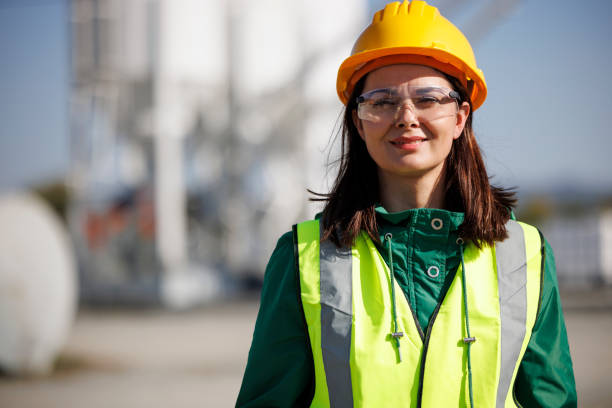 istock Smiling female engineer with hardhat and protective eyeglasses at factory industry workplace 1469988099