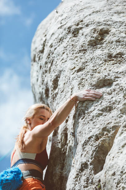 istock Athletic woman climbing on cliff rock 1469988155