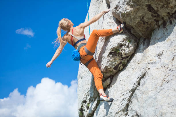 istock Athletic woman climbing on cliff rock 1469988306