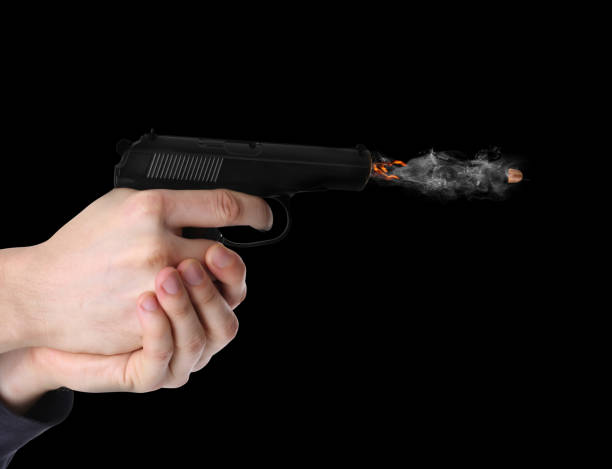 istock Man shooting from gun on black background, closeup 1469990575