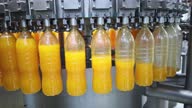 istock Machine filling plastic bottles with juice at the beverage factory 1469991779
