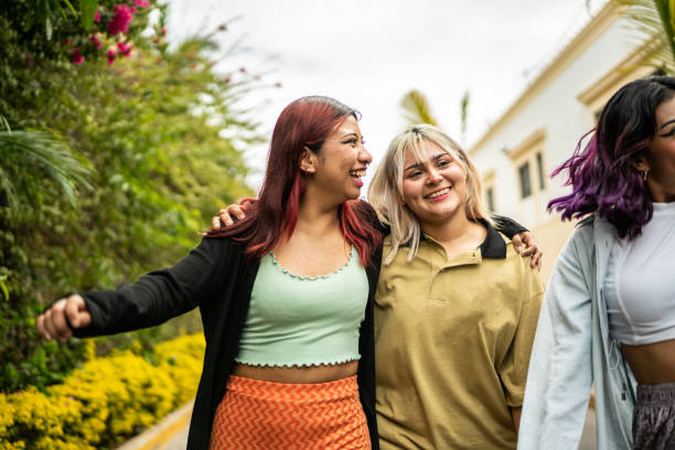 istock Female friends having fun while walking on the street 1469992239