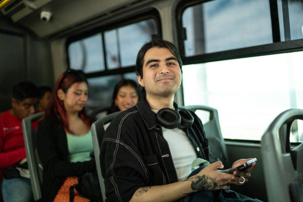 istock Portrait of young man using a mobile phone on a bus 1469992362