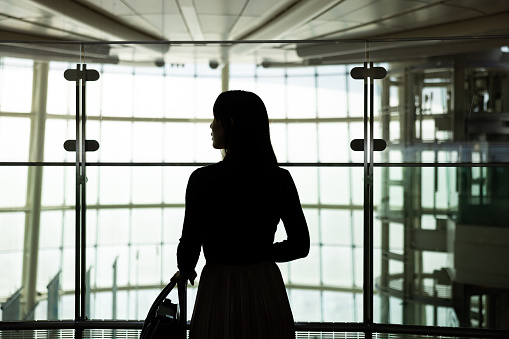 Silhouette of business woman in airport
