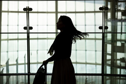 Silhouette of business woman in airport